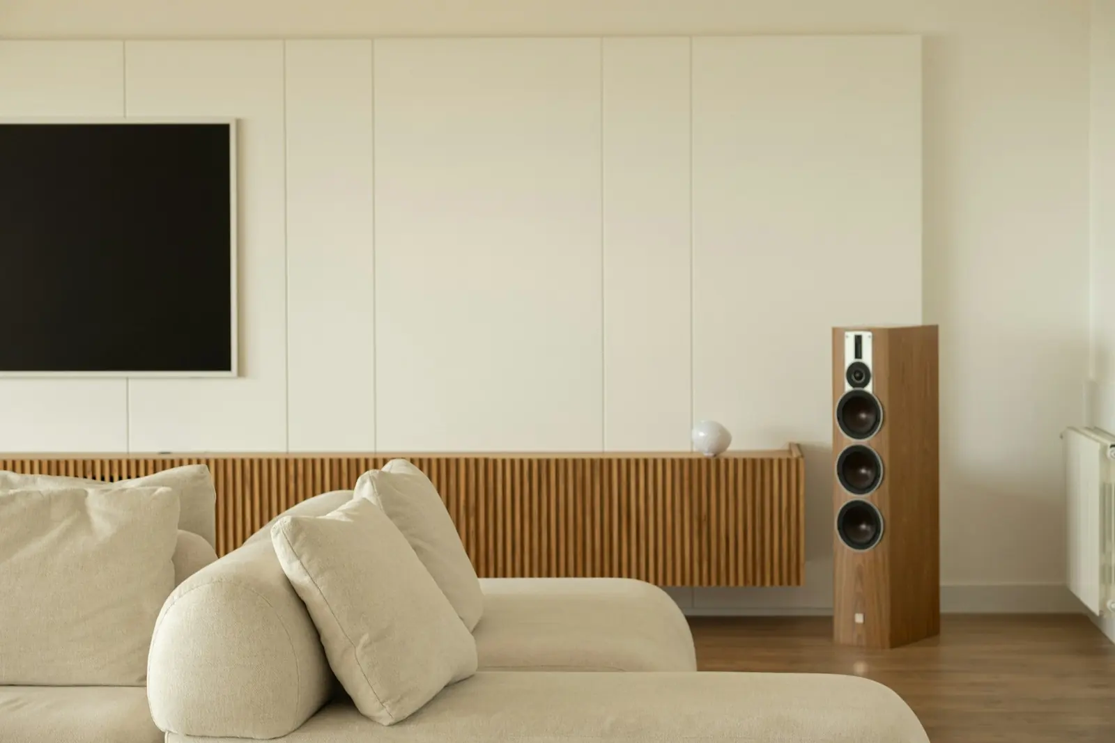 A living room with a TV on the wall